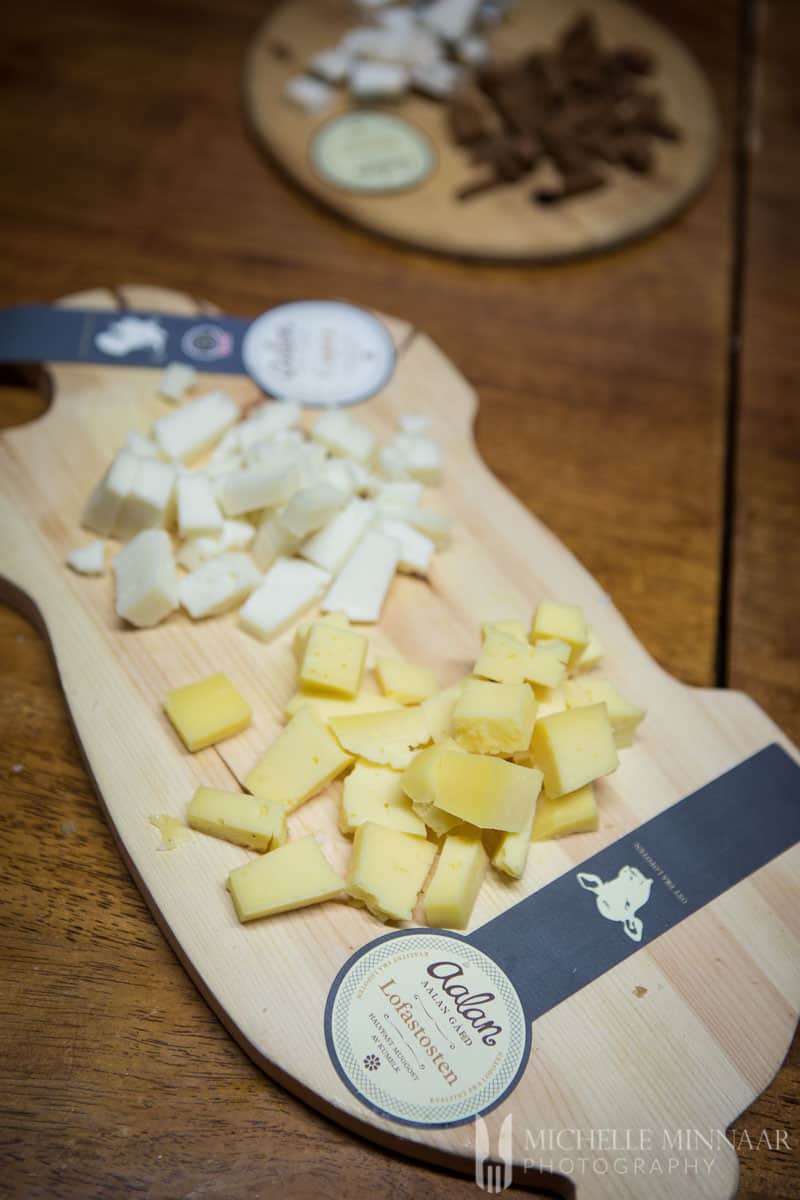 White and yellow cheese on a cutting board 