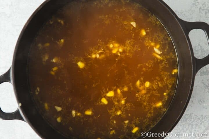 Stock and sweetcorn in a pot.