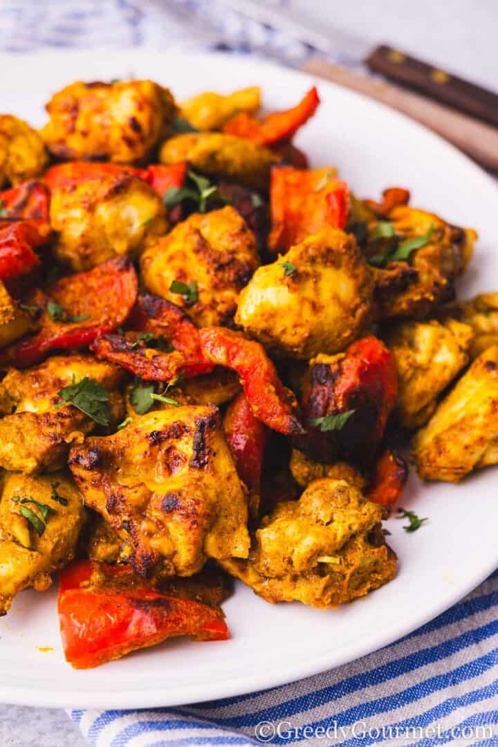 Air fryer chicken tikka served on a white plate.