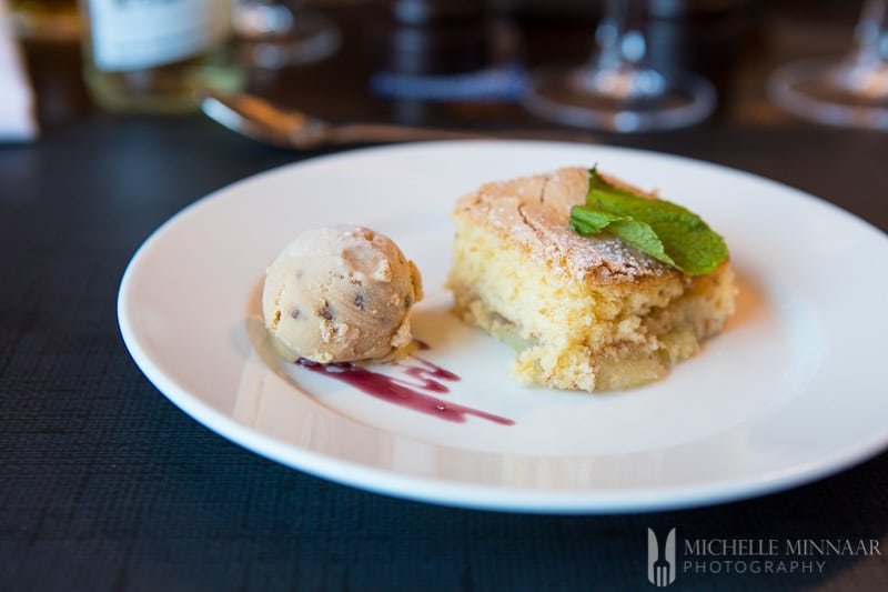 A cake and small scoop of ice cream 