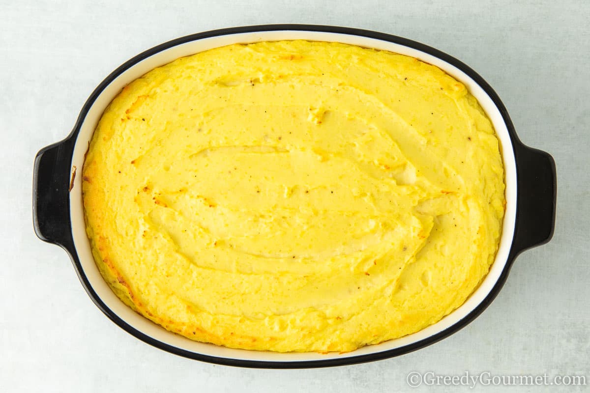 Baked mash potatoes in a serving dish.