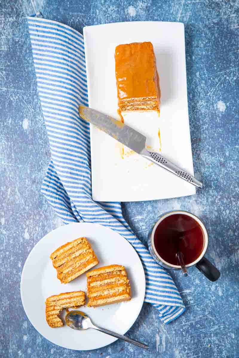 Plate of a full layered no bake biscuit cake and slices