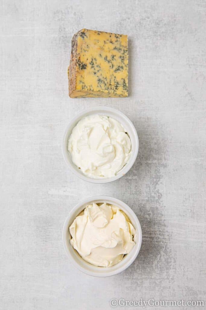 Chunk of blue cheese and ingredients to make a creamy dip 