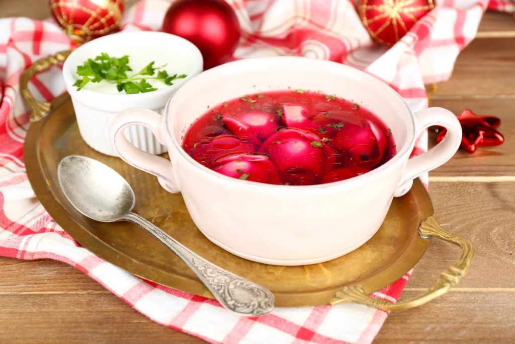 Bowl of a red coloured sour soup.