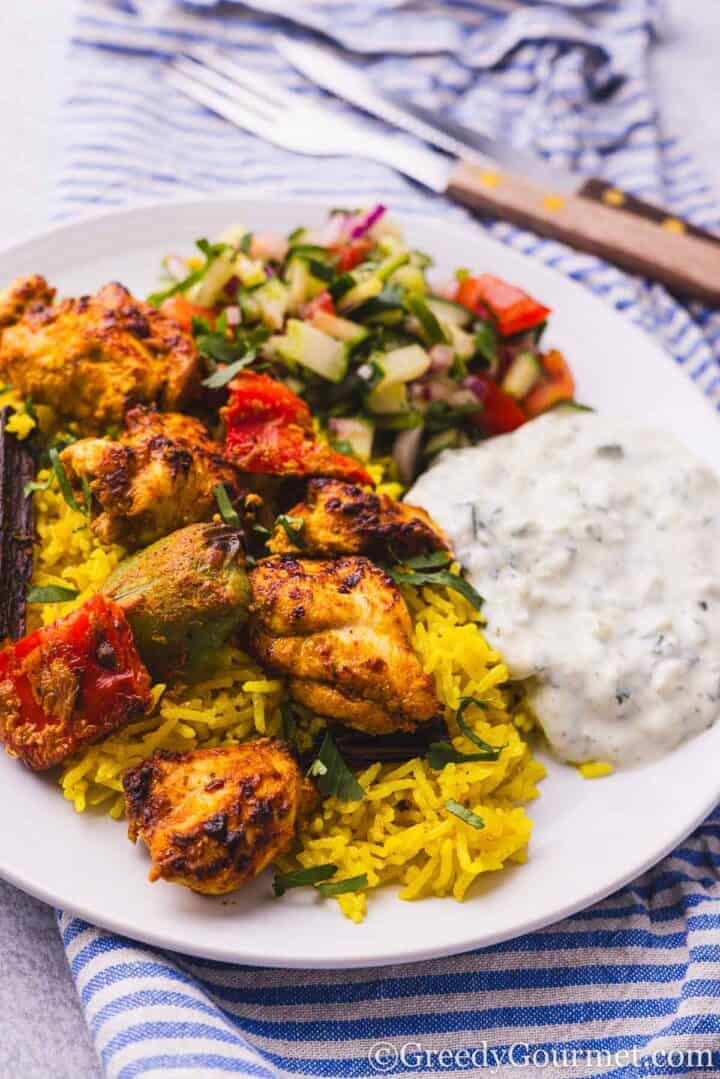 Air fryer chicken tikka served on a white plate.