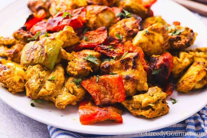 Air fryer chicken tikka served on a white plate.