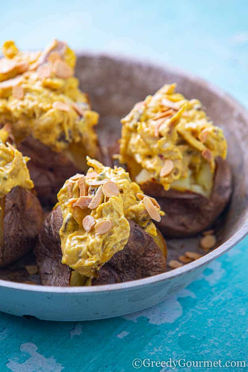 Close up of jacket potatoes filled with coronation chicken