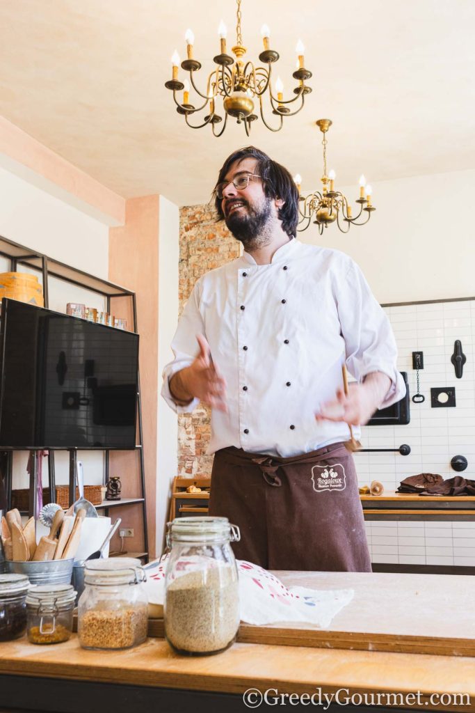 A man behind a counter in a Bakery.