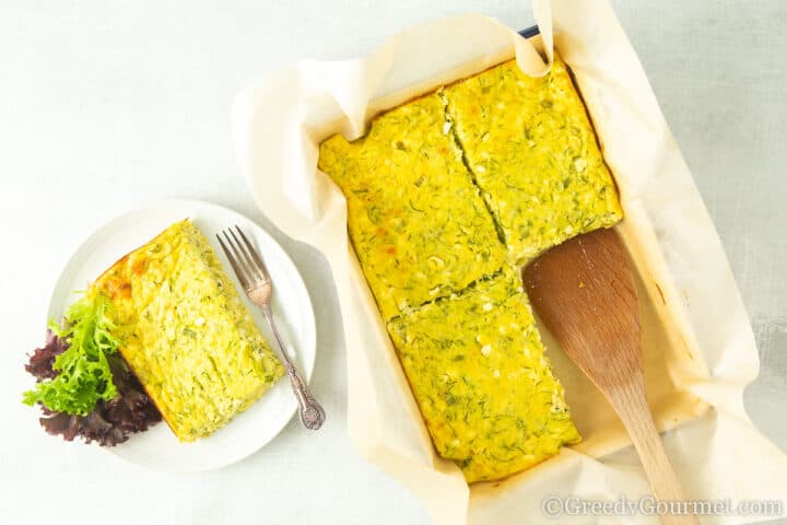 plate with egg bake and salad.