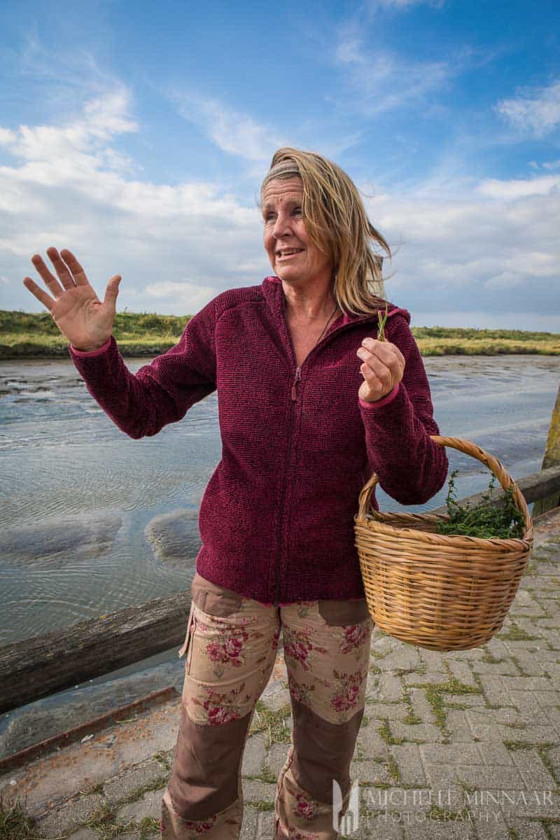 A woman holding a wicker basket 