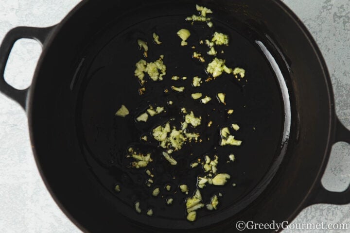 Frying garlic and ginger in a pan.