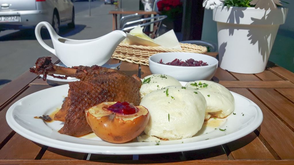 Pan fried duck meat served with potato dumplings and vegetables.