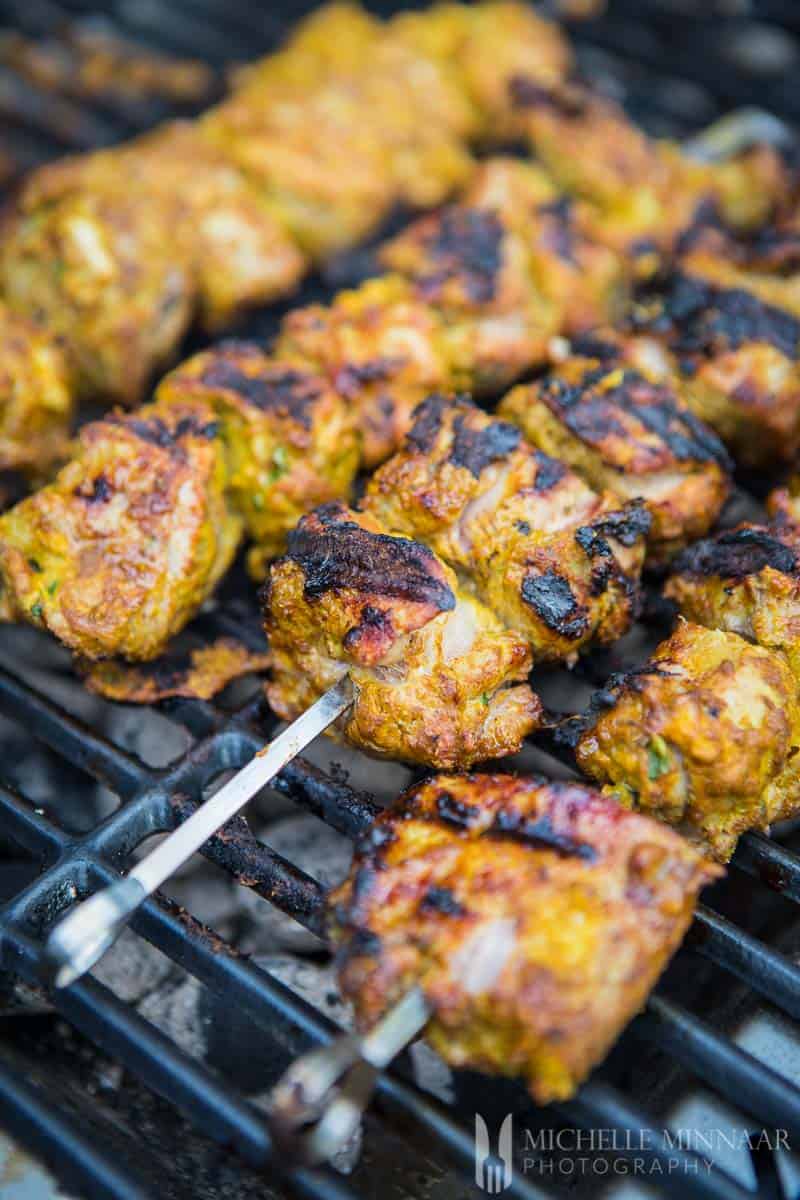 A close up of lamb being bbq'd on a grill 