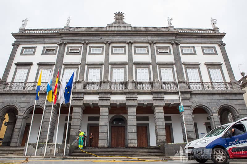 A white and grey building with flags outside