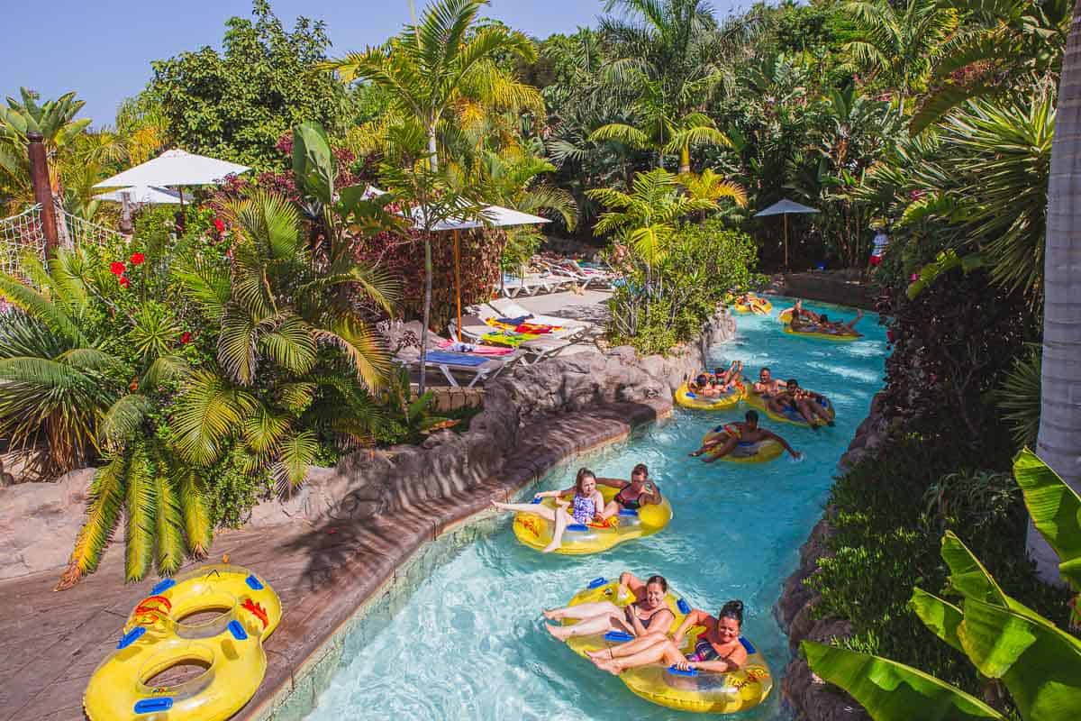 Mai Thai River ride at Siam Park. People floating on yellow tubes in the water.