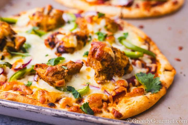 Freshly baked chicken tikka pizza.