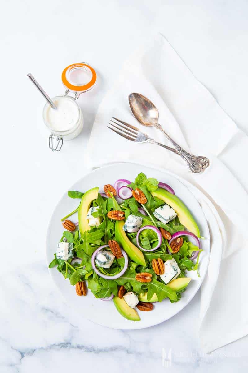 A fresh green rocket salad with avocado slices