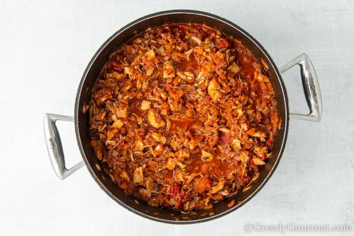 Shredded turkey in a stockpot to make a leftover turkey recipe