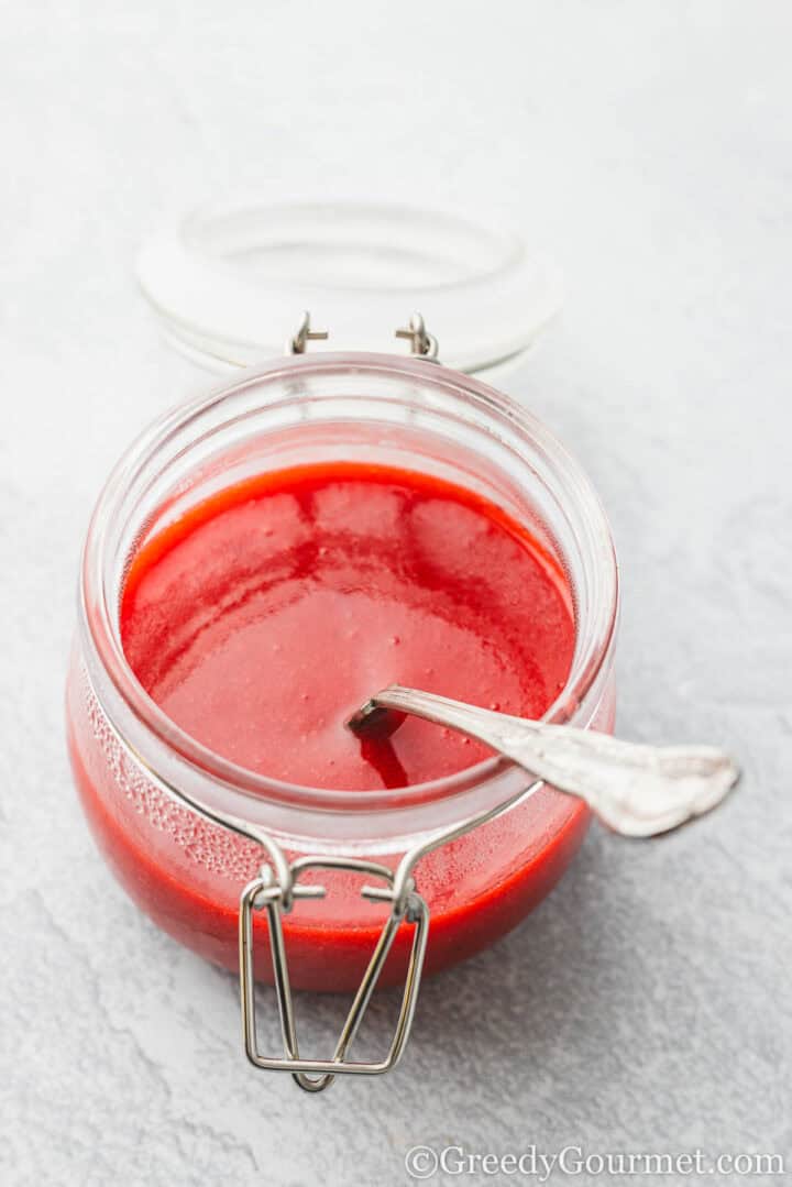 Glass jar or strawberry coulis.