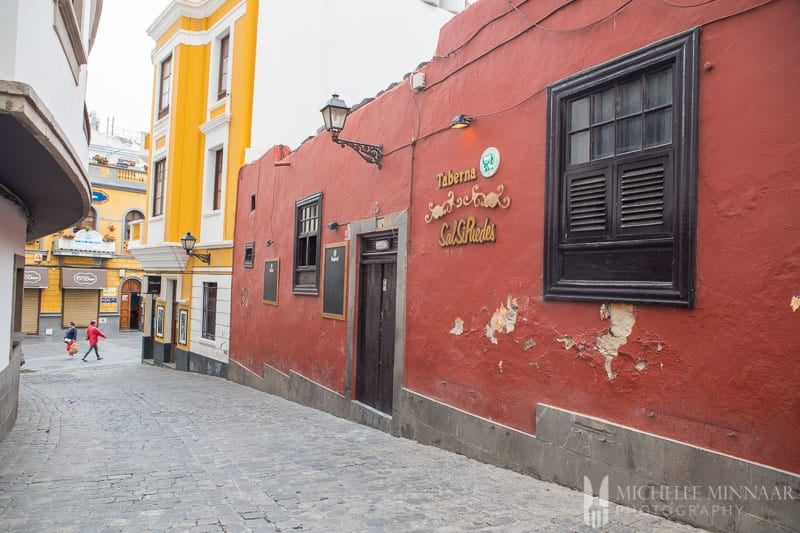 A red building down an alley 