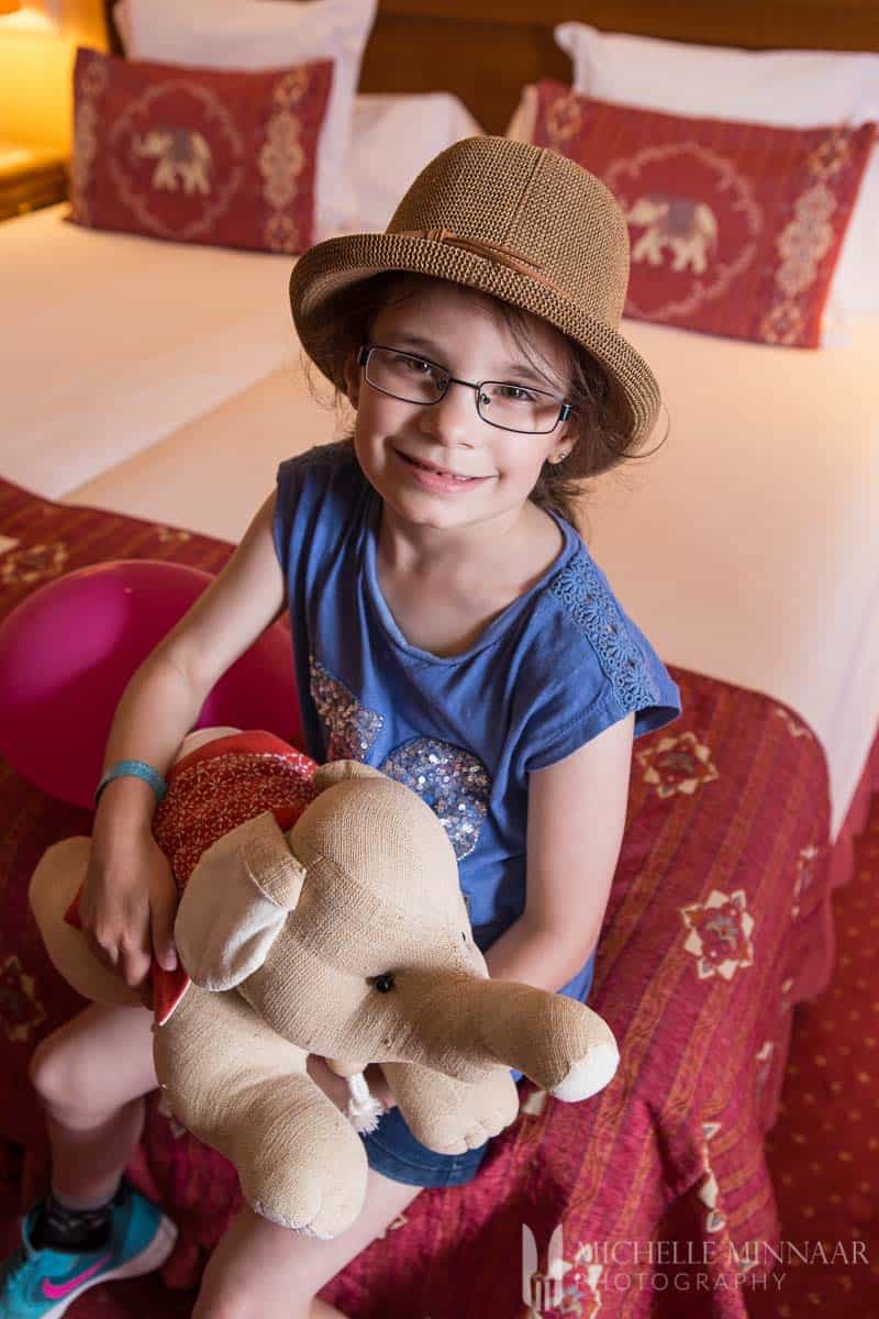 Girl holding elephant soft toy