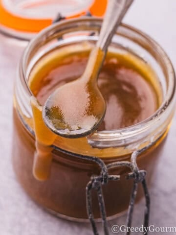 A jar of golden brown toffee sauce.