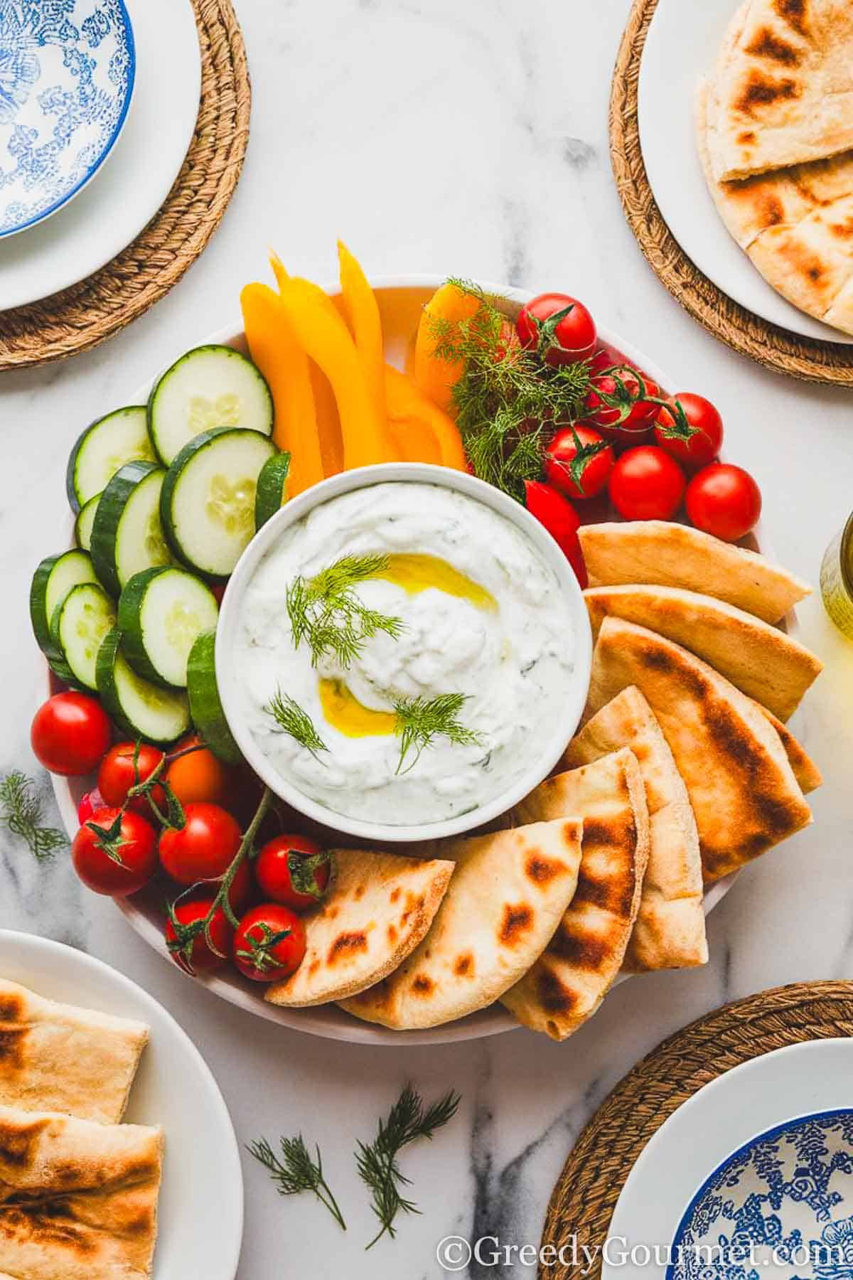 a plate of vegetable crudites and creamy yogurt dip