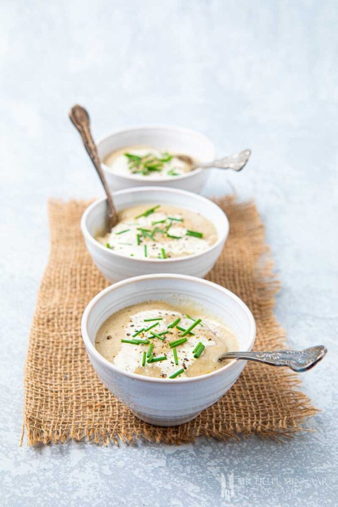 Three bowlfuls of Jerusalem artichoke Soup with cream and chives