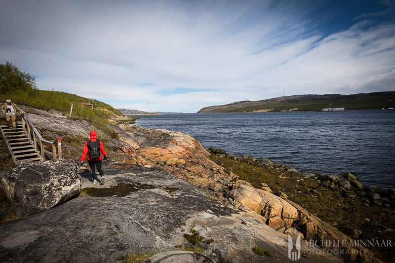 A man walking along the coast of Norway 