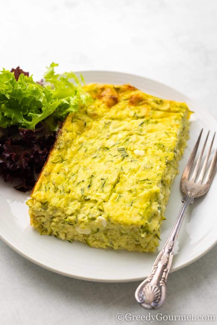 plate with egg bake and salad.